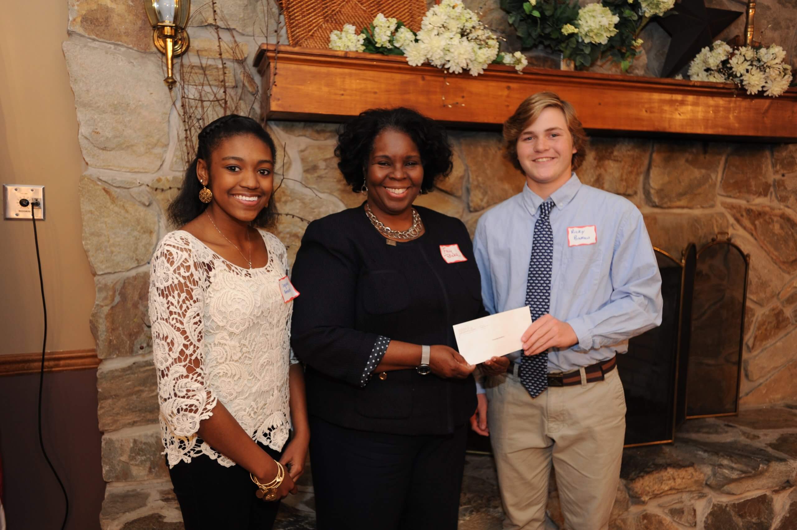 Sussex County YPB members Sequoia Bernard (left), a senior at Delmar High School and Rick Brokaw (right), a junior at Cape Henlopen High School, present a $1,500  grant to Fay Blake, Sussex County director for Pathways to Success. 